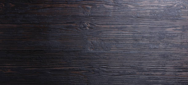 istock Burned black wooden texture background surface copy space for design 1130678742