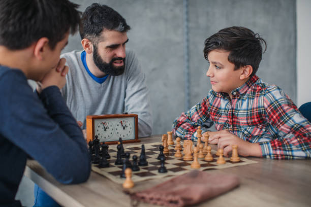 istock Young boys and chess teacher playing chess 1130679071