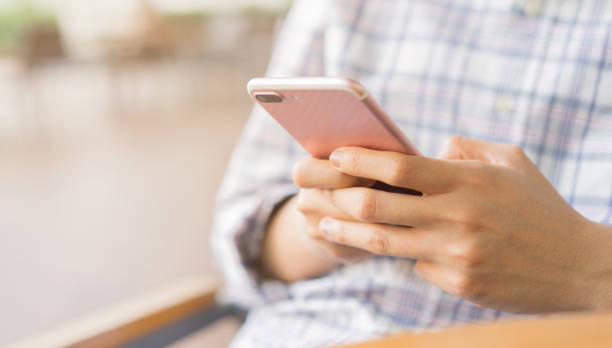 istock close up businessman holding smartphone for checking work or make appointment and using application for manage job or surf the internet at outside office , technology lifestyle concept 1130680698