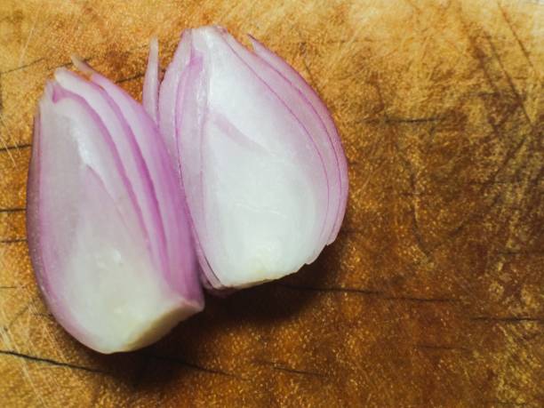 istock Shallots on wooden cutting board 1130681672