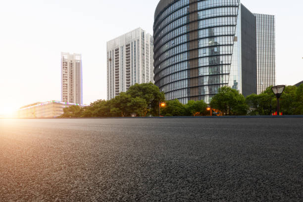 istock Asphalt pavement and modern architecture of city highway 1130682163