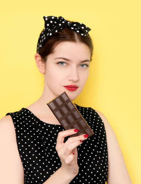 istock Woman eating chocolate 1130682844
