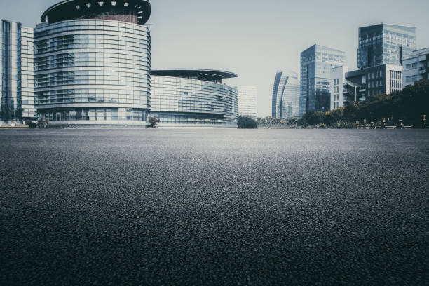istock Asphalt pavement and modern architecture of city highway 1130682920