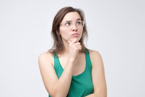 istock Serious woman in glasses thinking or dreaming 1130683159