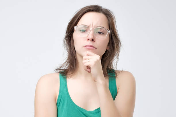 istock Serious woman in glasses thinking or dreaming 1130683171