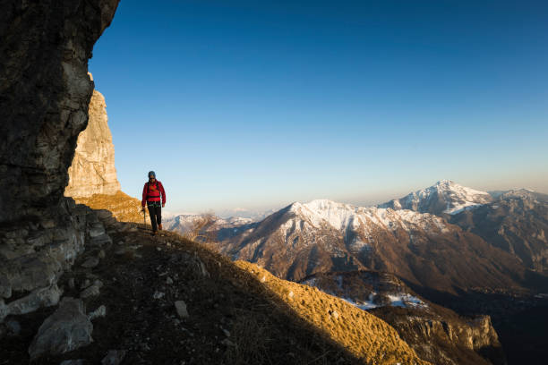 istock Mountaineer walking on mountain ridge 1130683227
