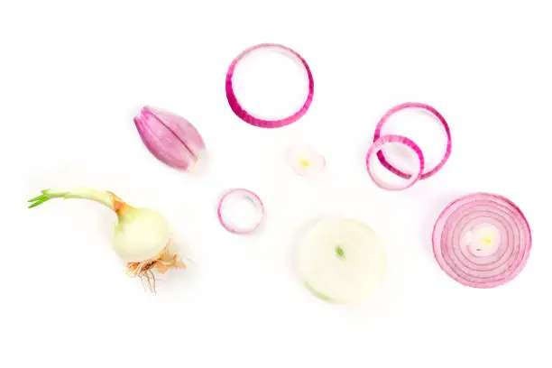 Red onions and shallots, shot from above on a white background with copy space