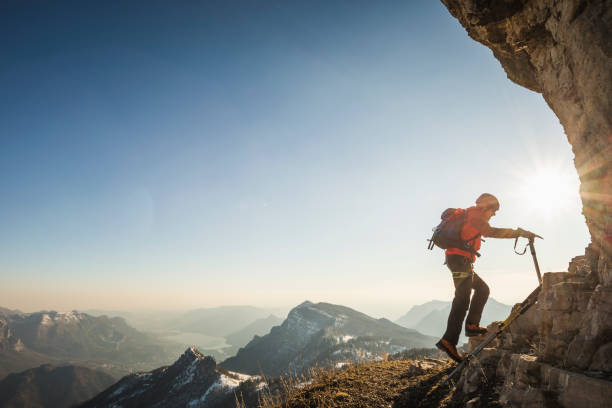 istock Alpinist walking on mountain ridge 1130683465