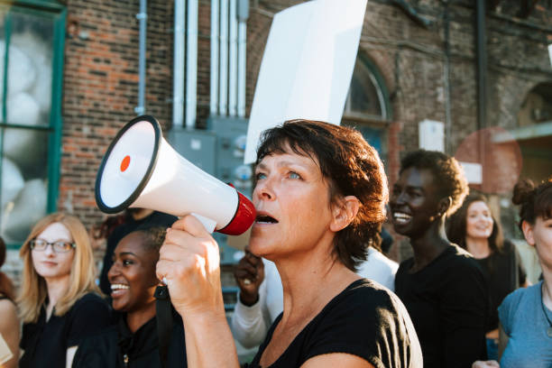 istock Feminist with a megaphone at a protest 1130683493