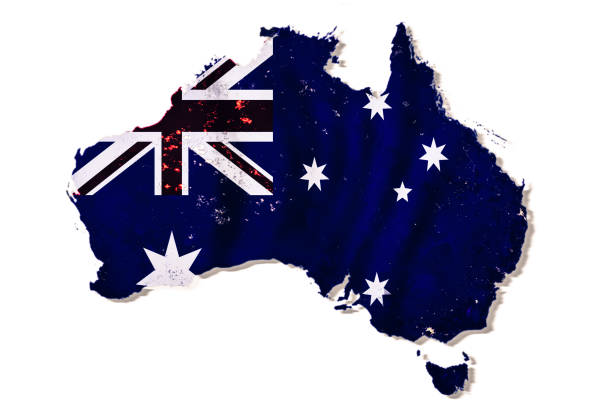 istock Australian flag on a continent map isolated on white background with shadow. Dark blue land with night city lights, collage. Elements of this image furnished by NASA. 1130684653