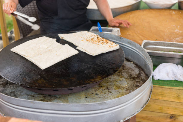 istock Man making savory gozleme flatbread in Turkey 1130684701