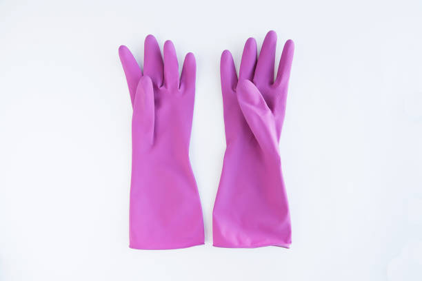 istock Purple rubber gloves isolated on white. 1130684777