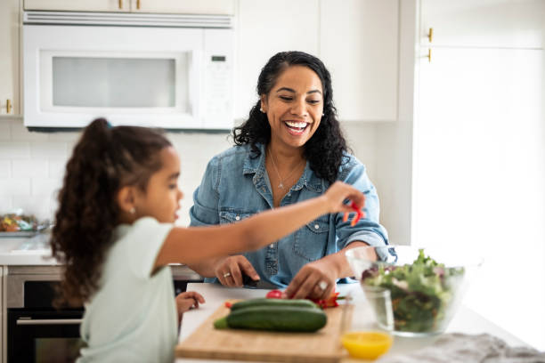 istock Mother and daughter preparing vegetables for lunch in the kitchen 1130684882