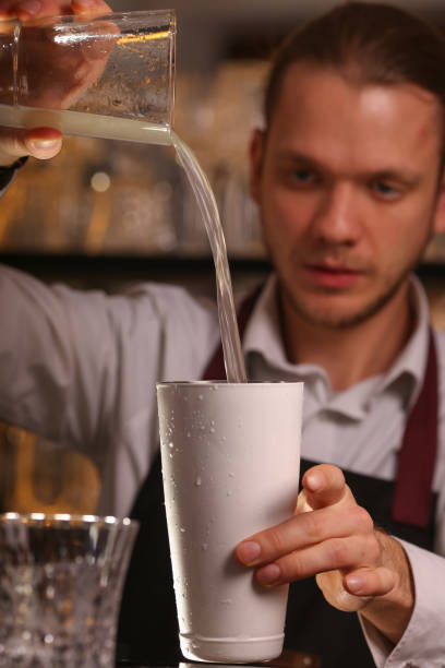 istock Barmen is making Fitzgerald cocktail. Fitzgerald alcohol cocktail on black background surface 1130685760