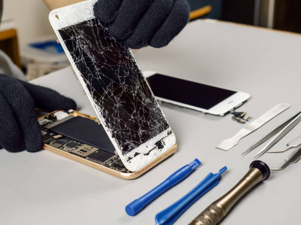 istock Technician repairing broken smartphone on desk 1130685818