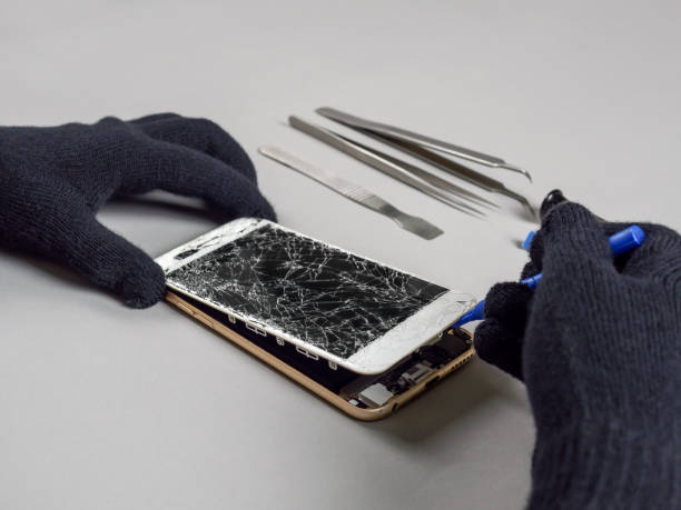 istock Technician repairing broken smartphone on desk 1130685870