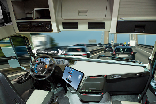 Self driving truck with head up display on a road. Inside view.