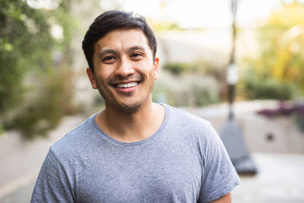 istock Hispanic adult standing outside and smiling 1130685983
