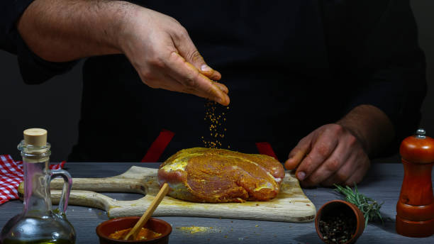 istock Chef cooking Grill striploin steak with spices. Food concept background 1130686345