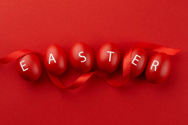 red easter eggs with letters arranged in a word - easter eggs red imagens e fotografias de stock