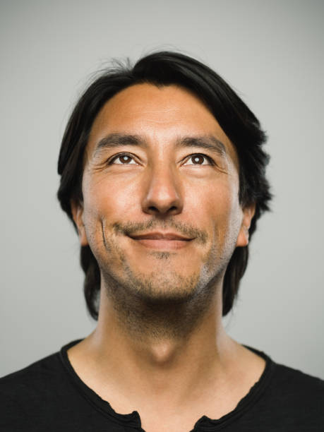 istock Portrait of real hispanic man with happy expression looking up 1130687601