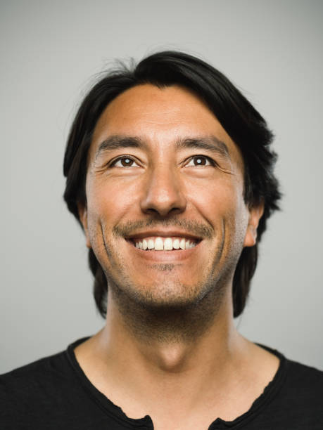 istock Portrait of real hispanic man with happy expression looking up 1130687672