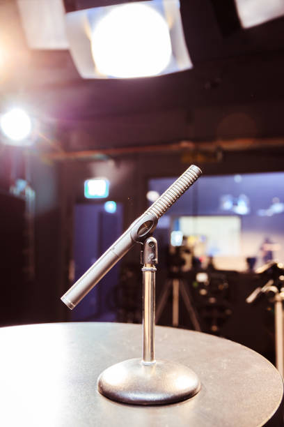 istock Speaker on the stage: Young Caucasian man is talking into a mirophone 1130692408