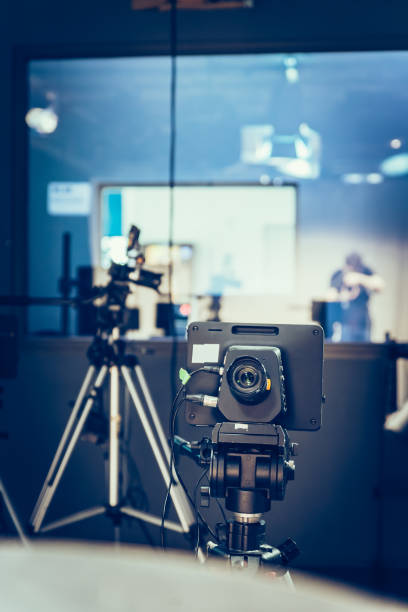 istock Modern film camera on a tripod in a broadcasting studio, spotlights and other equipment 1130692424