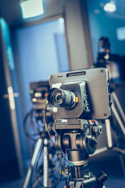 istock Modern film camera on a tripod in a broadcasting studio, spotlights and other equipment 1130692440