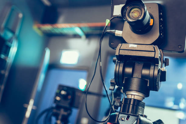 istock Modern film camera on a tripod in a broadcasting studio, spotlights and other equipment 1130692468
