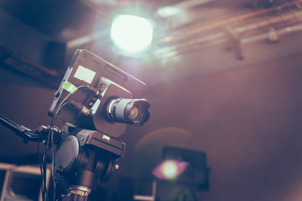 istock Modern film camera on a tripod in a broadcasting studio, spotlights and other equipment 1130692484