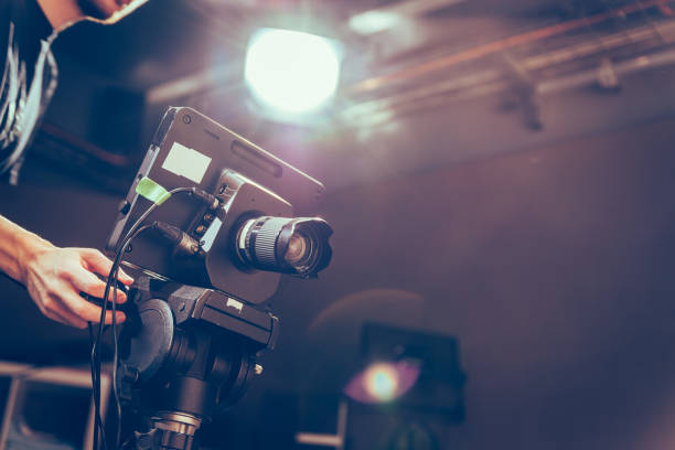 istock Modern film camera on a tripod in a broadcasting studio, spotlights and other equipment 1130692495