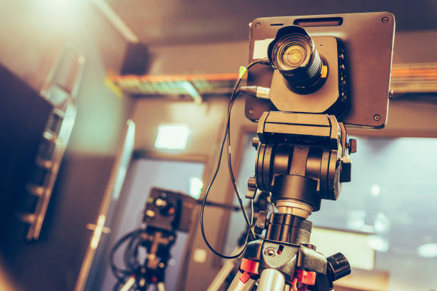 istock Modern film camera on a tripod in a broadcasting studio, spotlights and other equipment 1130694155