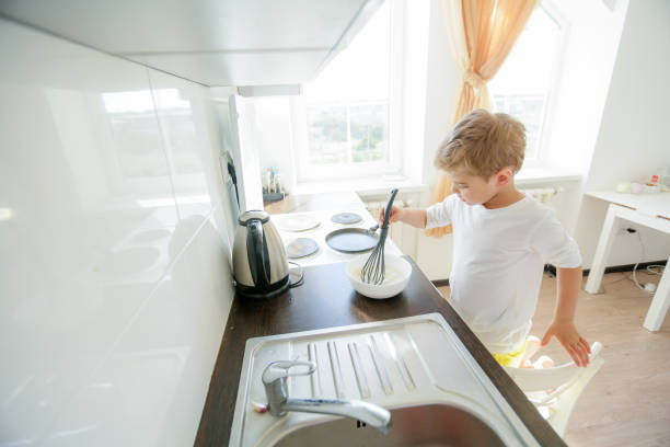istock little boy enjoy cooking in kitchen interior 1130696510