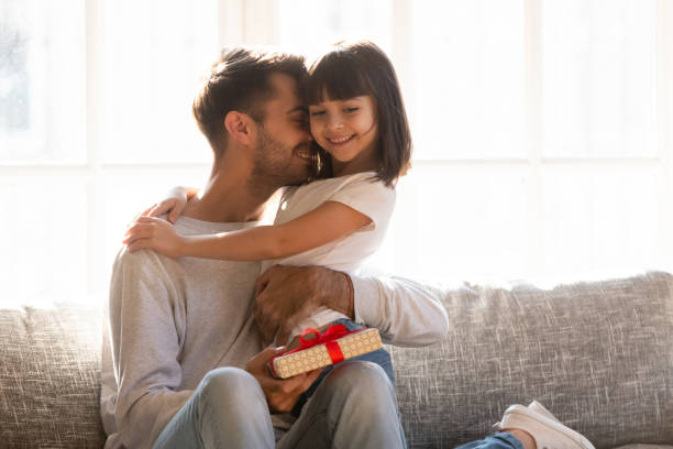 istock Grateful dad hugging daughter thanking for gift on fathers day 1130696699