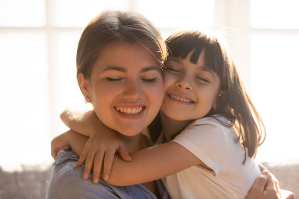 istock Loving affectionate little kid daughter hugging happy mom cuddling 1130696722