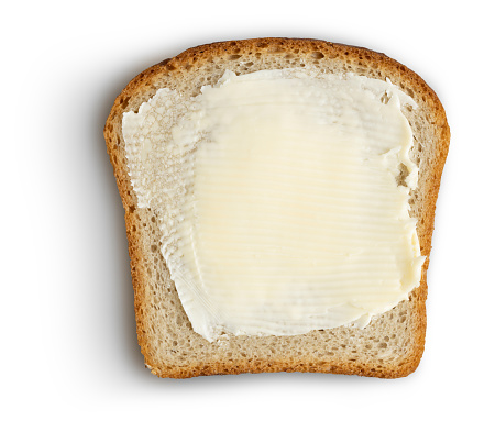 Bread slice with butter on white clipping path included. This file is cleaned and retouched.