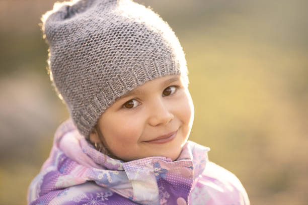 istock Smiling cute little girl in grey hat 1130696963
