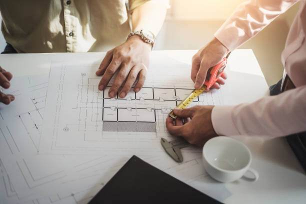 istock engineer people meeting working and pointing at a drawings in office for discussing. Engineering tools and construction concept. 1130699504