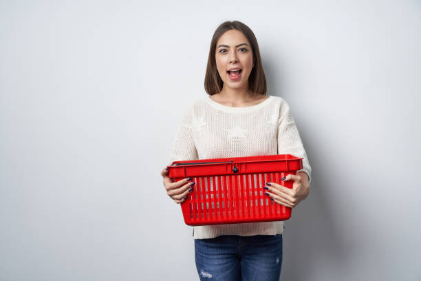 istock Excited surprised woman holding empty shopping basket 1130700036