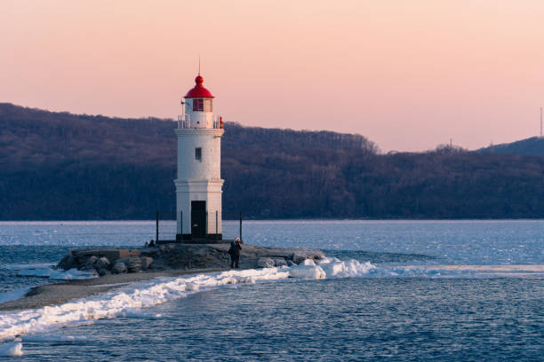 istock White lighthouse with red roof on Tokarev cat. 1130700360
