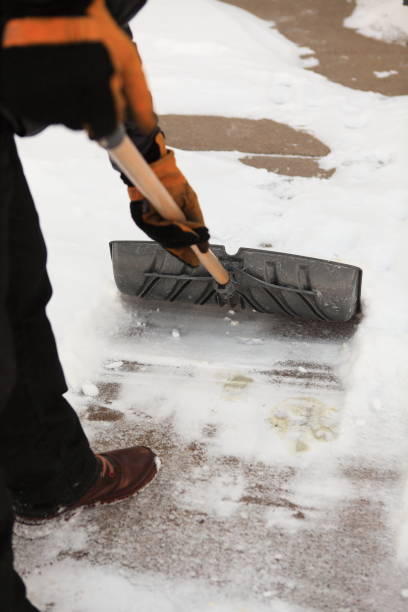 istock Man clean a sidewalk by shovel 1130701577