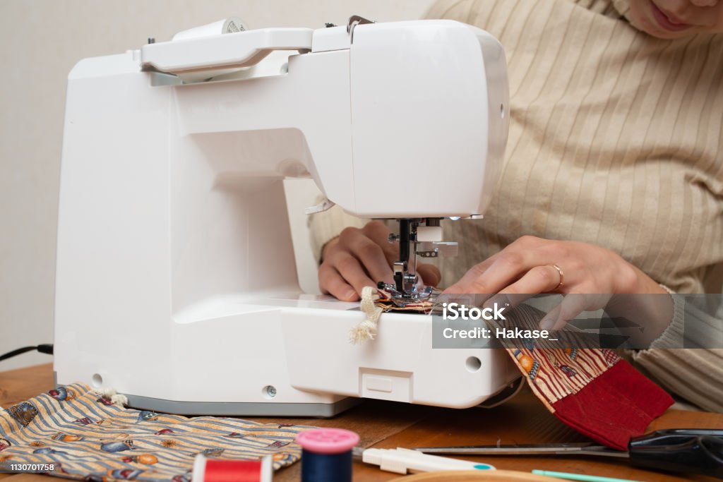 Woman to operate the sewing machine 30-39 Years Stock Photo