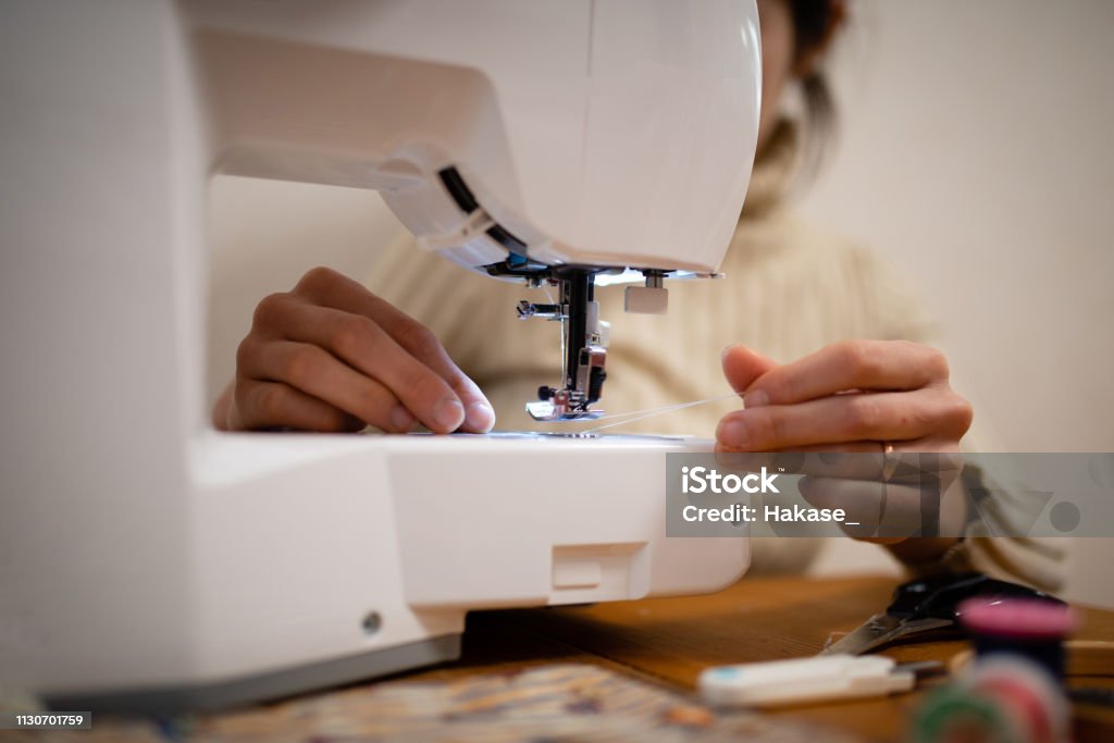 Woman to operate the sewing machine 30-39 Years Stock Photo