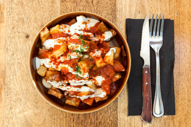 A dish of Papas bravas, made with potatoes, peppers ad garlic. Typical meal from Tarifa, Andalusia, Spain. Picture of a dish of Papas bravas, made with potatoes, peppers ad garlic. Typical meal from Tarifa, Andalusia, Spain. gibraltar photos stock pictures, royalty-free photos & images