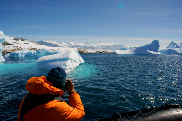 istock Tourists viewing iceberg, Antarctica. 1130703321
