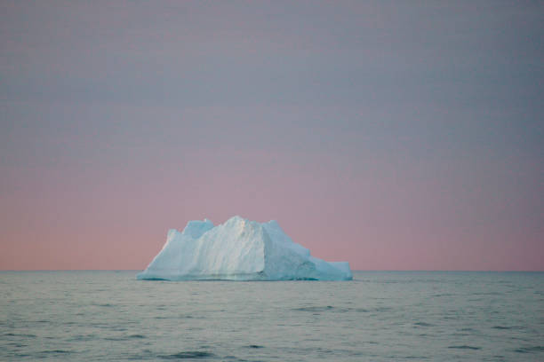 istock Floating Iceberg and Setting Sun in Antarctica 1130707868