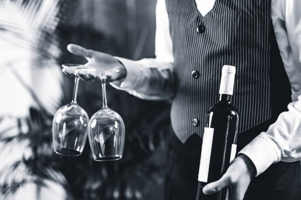 istock Midsection Of Bartendar Serving Wine In Bar 1130708083