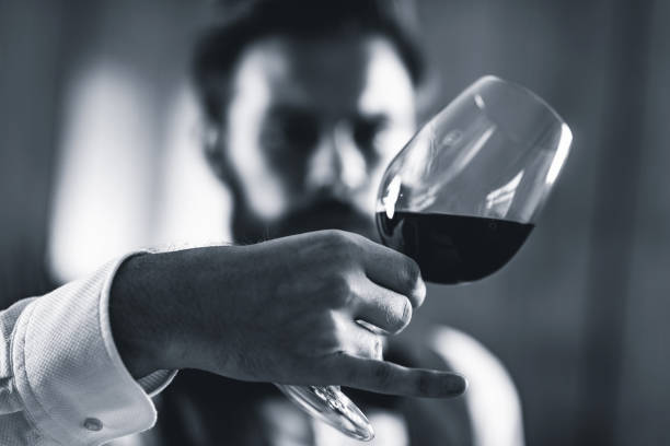 istock Bartendar Looking At Wineglass In Bar 1130708102