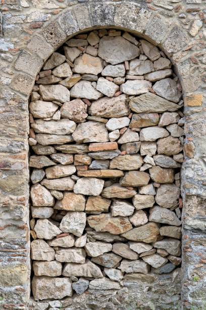 istock ancient stone wall with an arch in a niche 1130709465